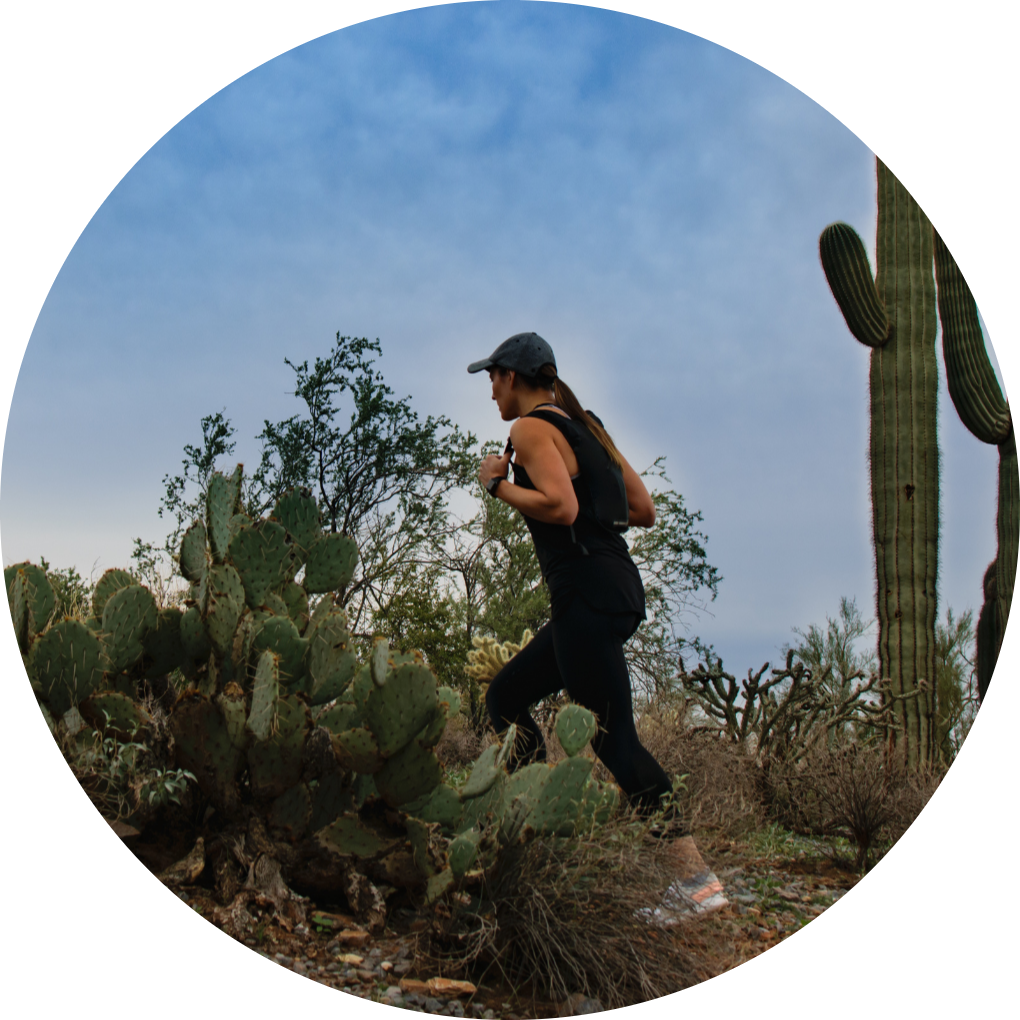 woman hiking up a desert trail