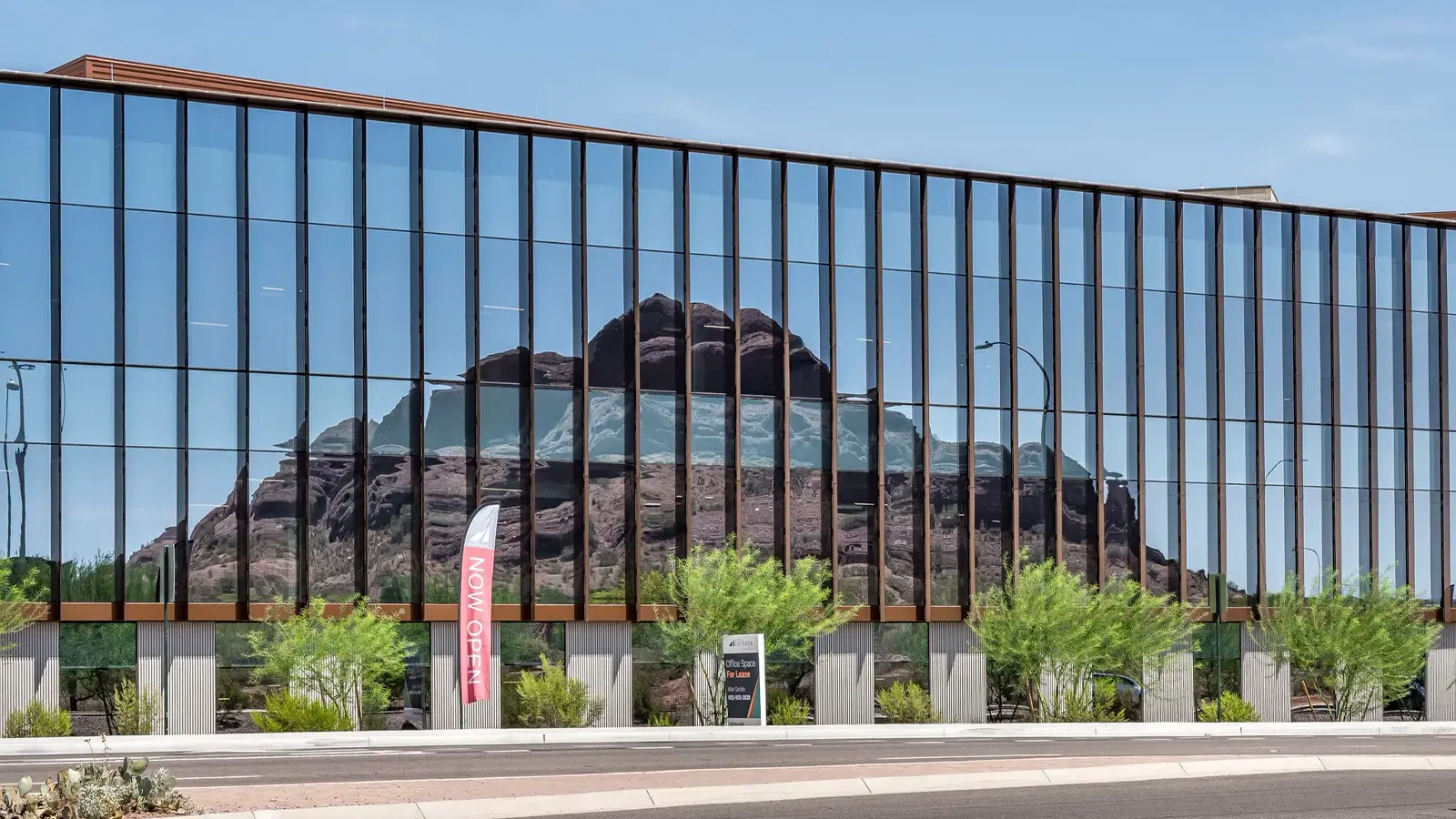 Entrada office building with reflection of Papago mountain on the mirrored surface.