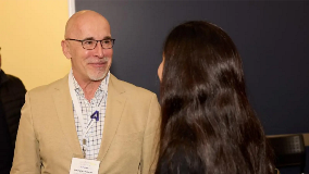 Affinaquest CEO talking to a woman