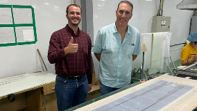 Owner next to a solar panel assembly table