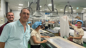 Owner with employees assembling solar panels