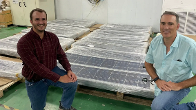 Owner next to wrapped solor panels